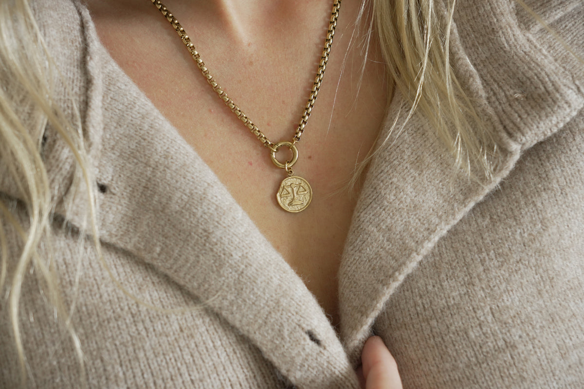 Zaya Libra Gold Zodiac Charm by Boho Betty – a waterproof gold Libra coin charm, styled on a gold chain necklace