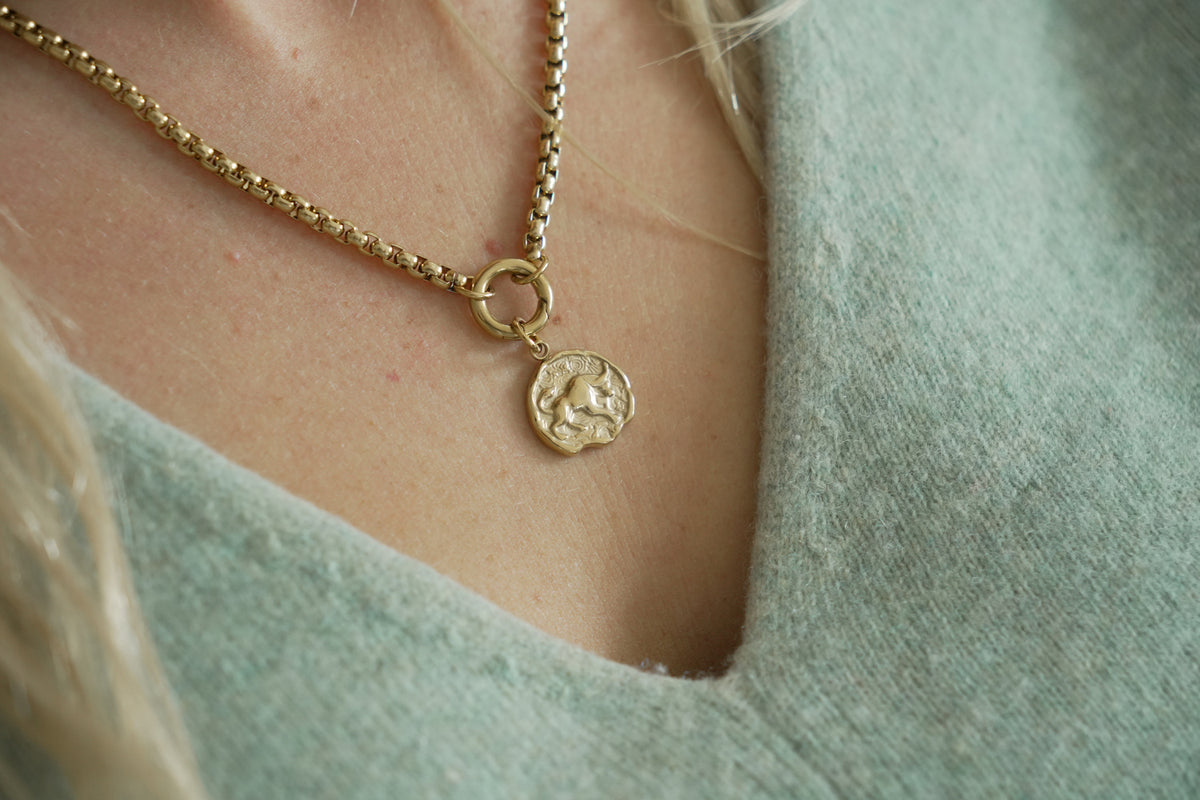 Zaya Taurus Gold Zodiac Charm by Boho Betty – a waterproof gold Taurus coin charm, styled on a gold chain necklace