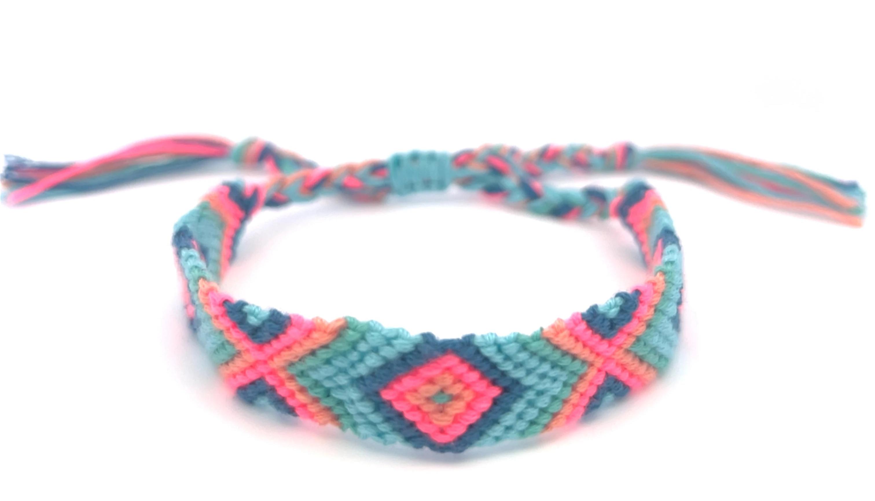 Turquoise and hot pink braided friendship on a white background