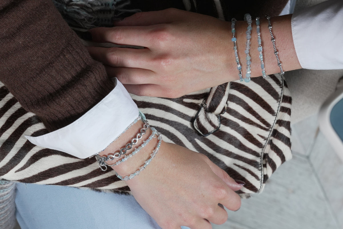 Bliss silver and blue topaz bead slider bracelet by Boho Betty – styled in a stack, a blue topaz beaded slider bracelet