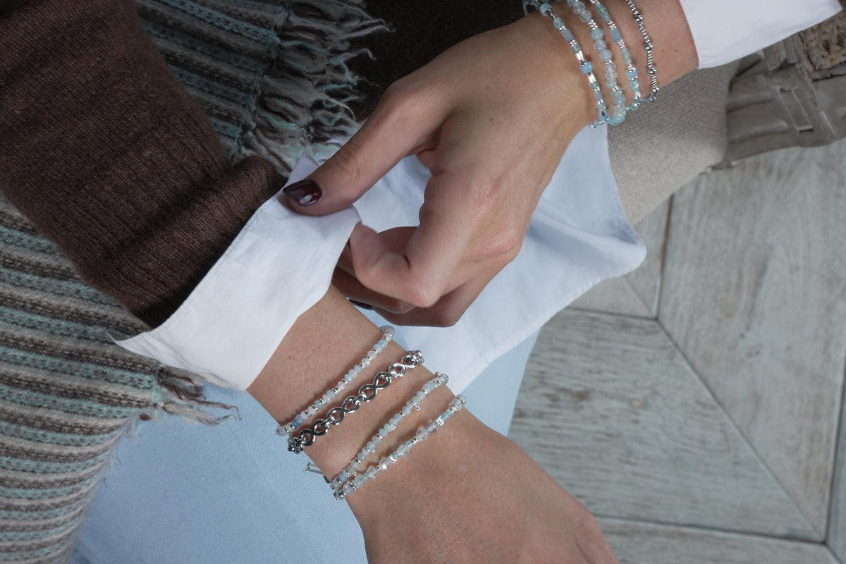Mystical silver and blue topaz gemstone slider bracelet by Boho Betty – styled in a stack, a blue topaz slider bracelet
