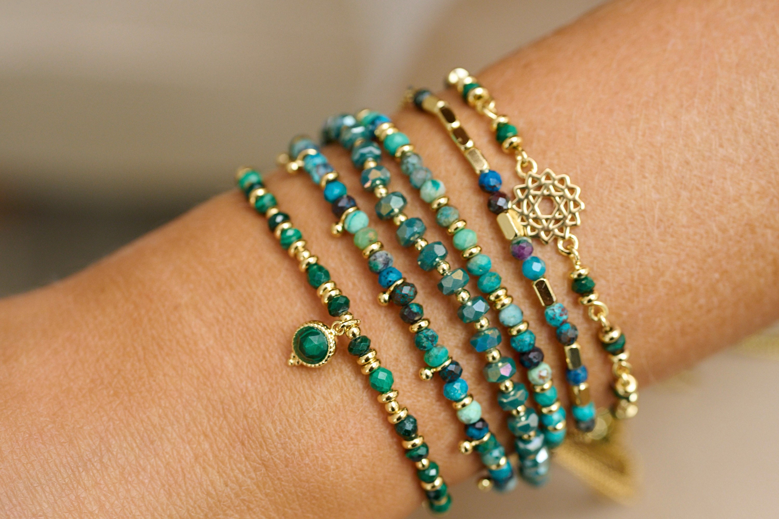 Prunus AB Green & Gold Crystal Stretch Bracelet - Boho Betty in a lifestyle picture containing multiple green gemstone bracelets 