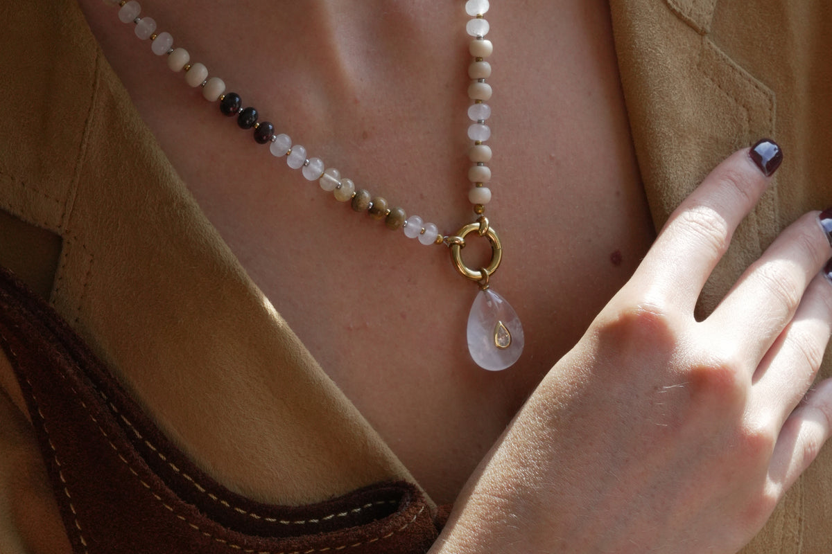Amala gold and brown mix bead necklace by Boho Betty – a gold brown beaded charm carrier necklace. Paired with Fleur Clear Quartz Pendant by Boho Betty