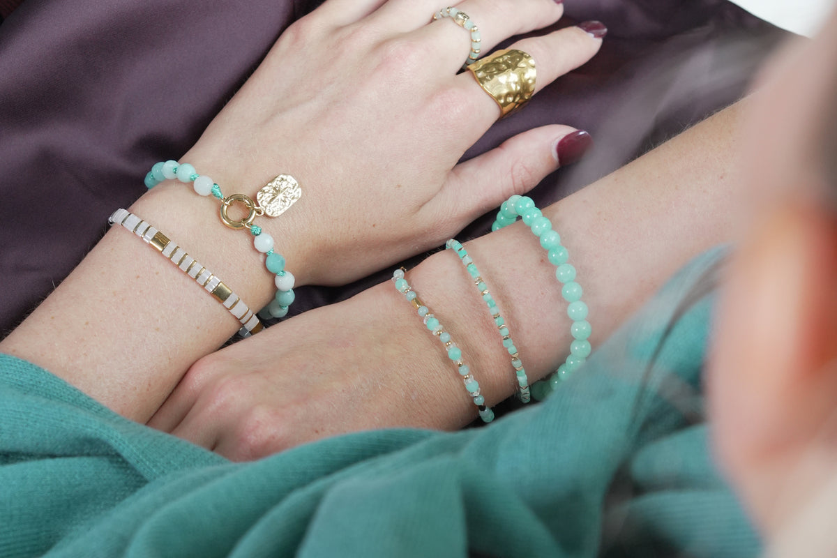 Delicado gold and white Tila bracelet by Boho Betty – styled in a stack, a gold and white Tila beaded stretch bracelet