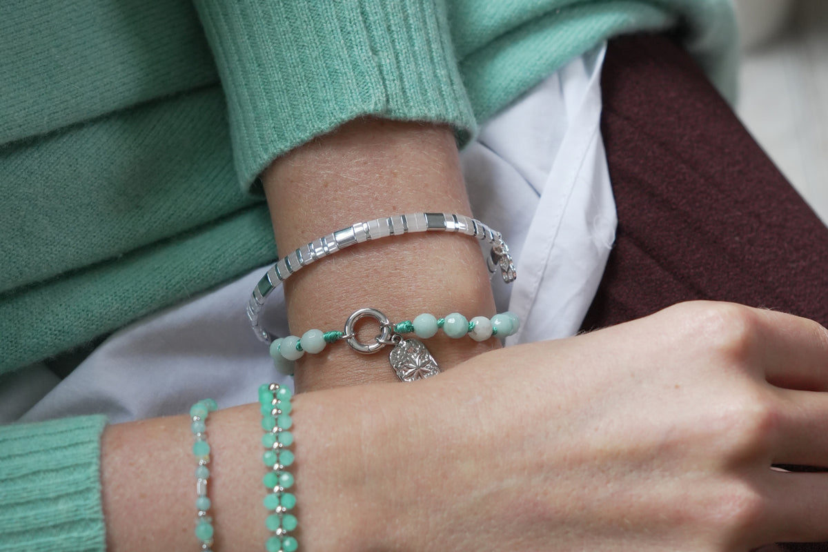 Delicado silver and white Tila bracelet by Boho Betty – styled in a stack, a silver and white Tila beaded stretch bracelet