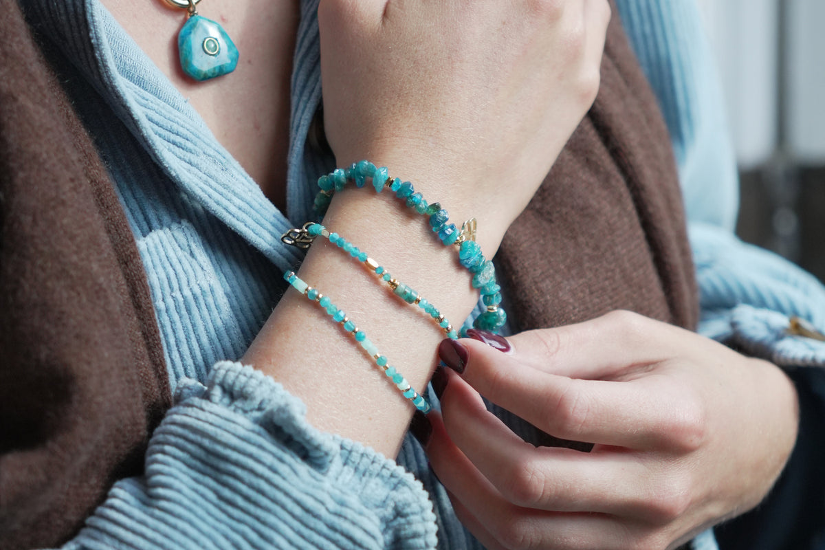 Sana apatite and gold stretch bracelet by Boho Betty – styled in a stack, a gold apatite gemstone beaded stretch bracelet