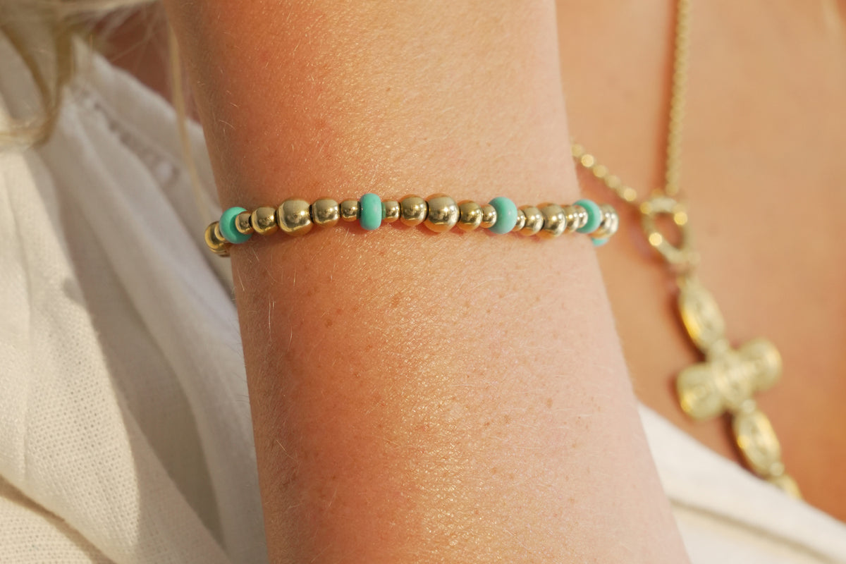 Sela turquoise howlite gold bead slider bracelet by Boho Betty – styled in a stack, a gold bead and howlite slider bracelet
