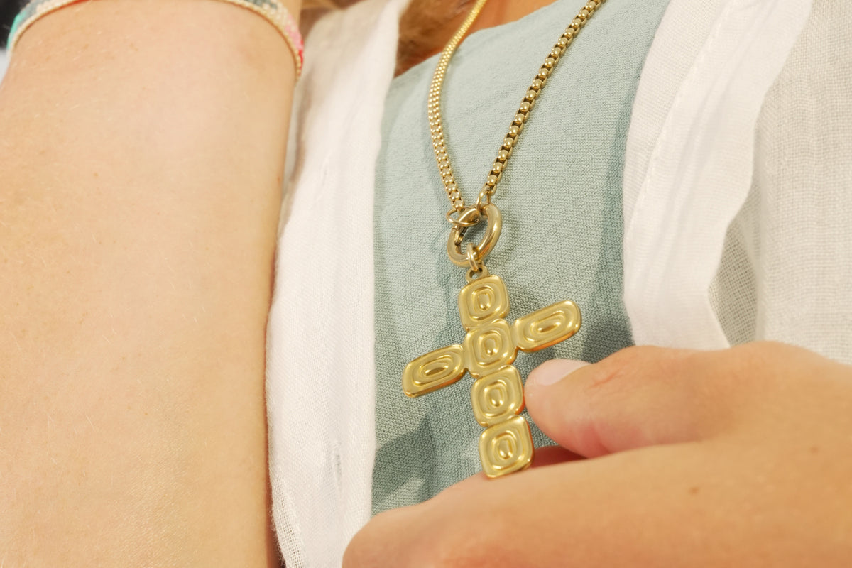 Thalia gold cross pendant necklace by Boho Betty – layered with other jewellery, a long gold chain with a cross pendant