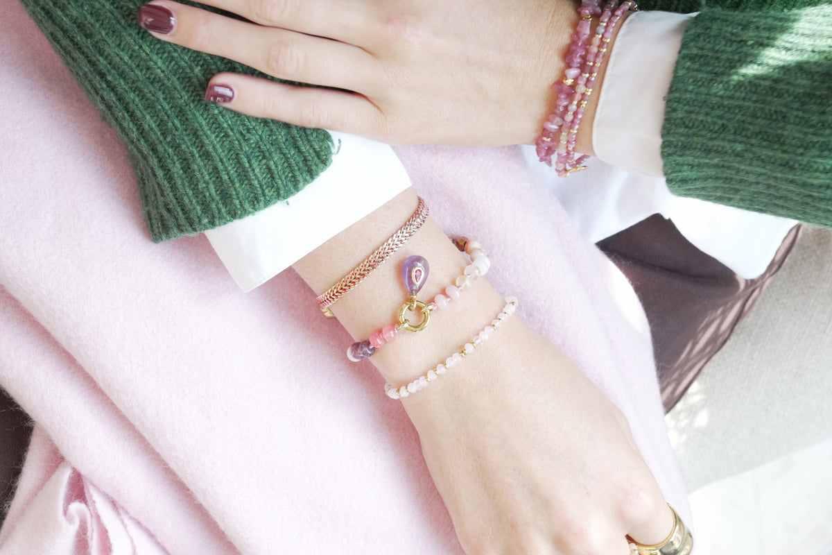 Zaha red mix and Fleurette amethyst bracelet by Boho Betty – styled in a stack, a gold amethyst beaded charm carrier bracelet
