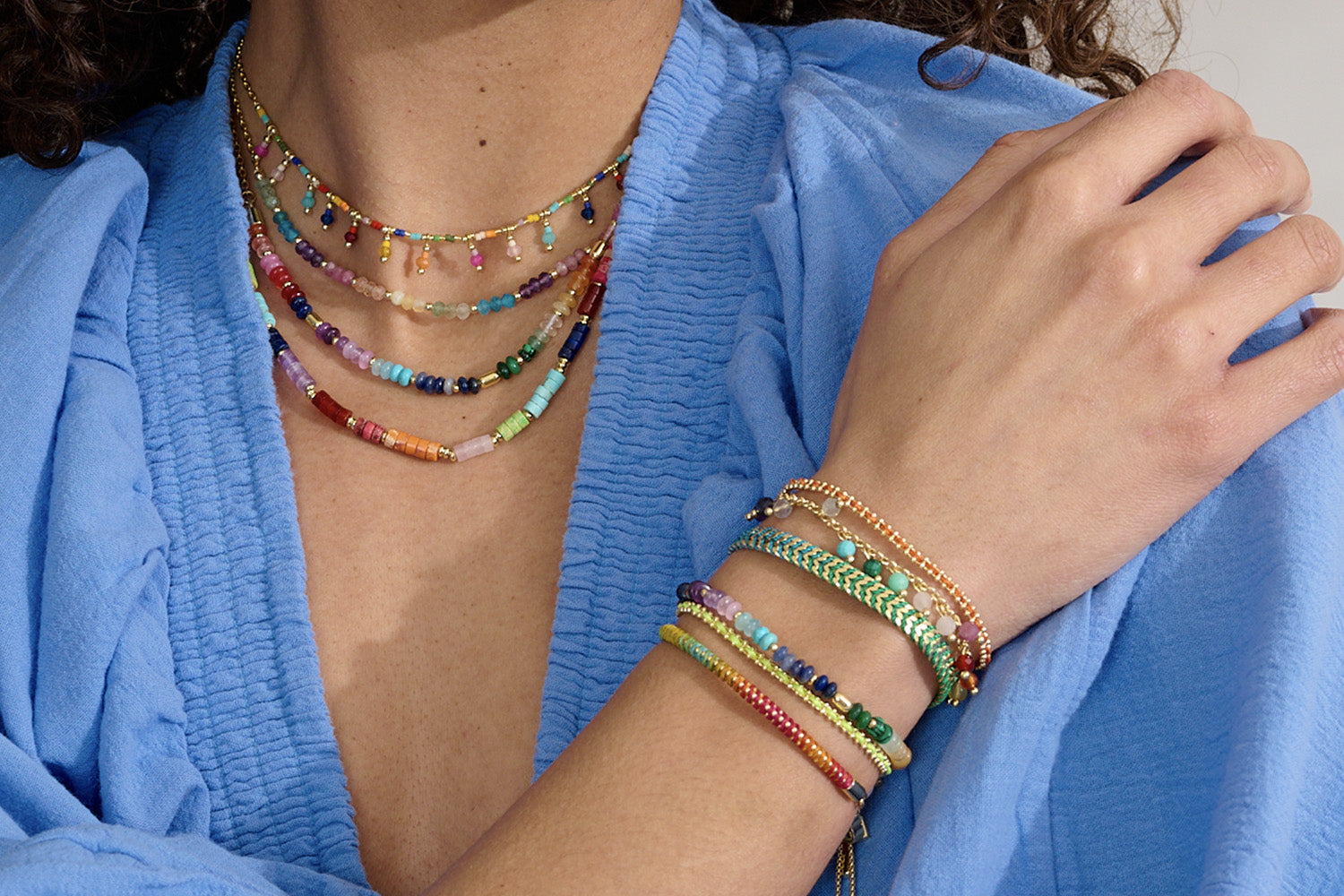 Lifestyle picture showcasing Boho Multicoloured layered gemstone necklaces - Colourful fun summer styling 