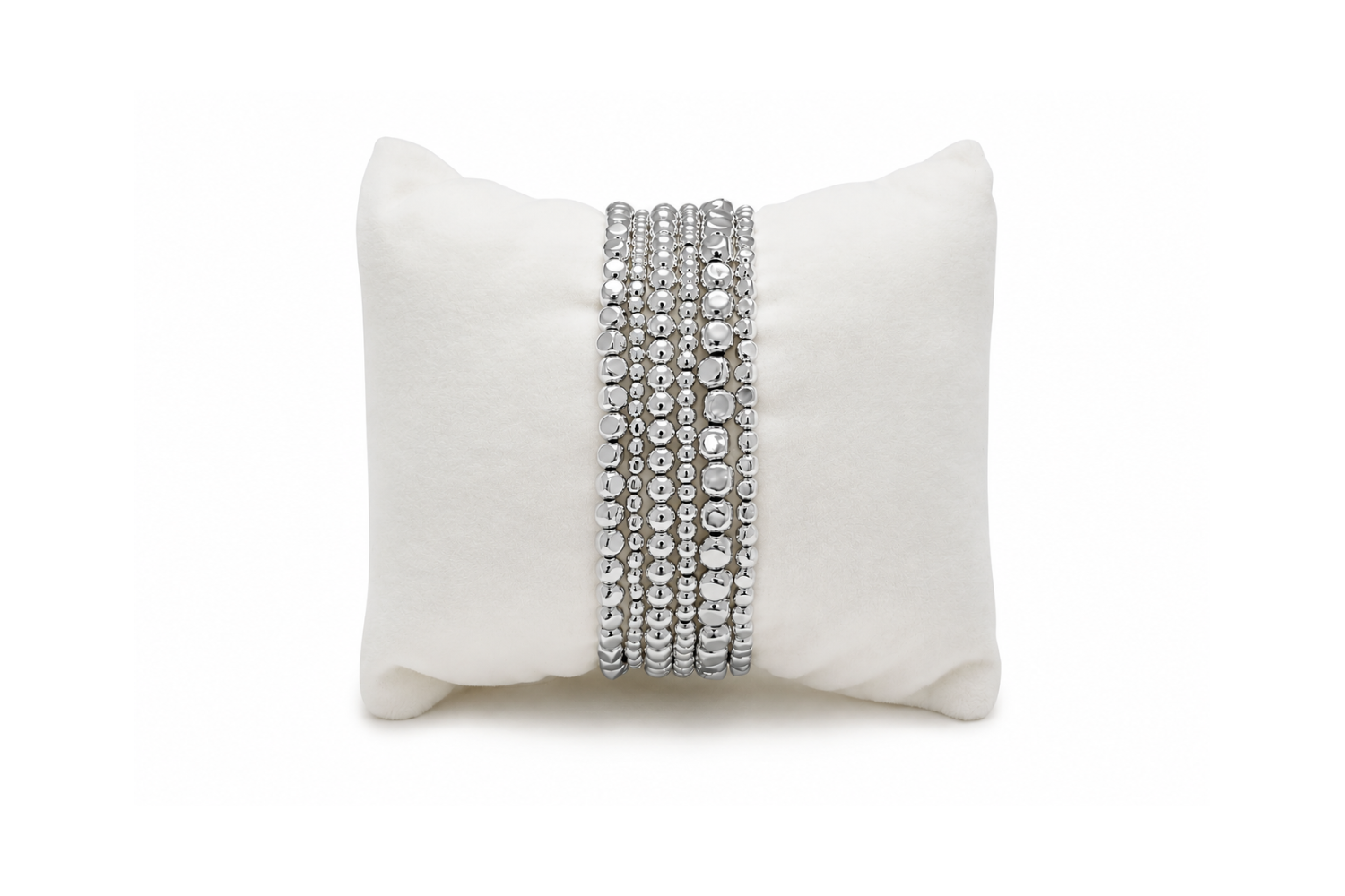 6 white gold stretch bracelets displayed on a luxurious Boho Betty Velvet cushion. The perfect gift for her