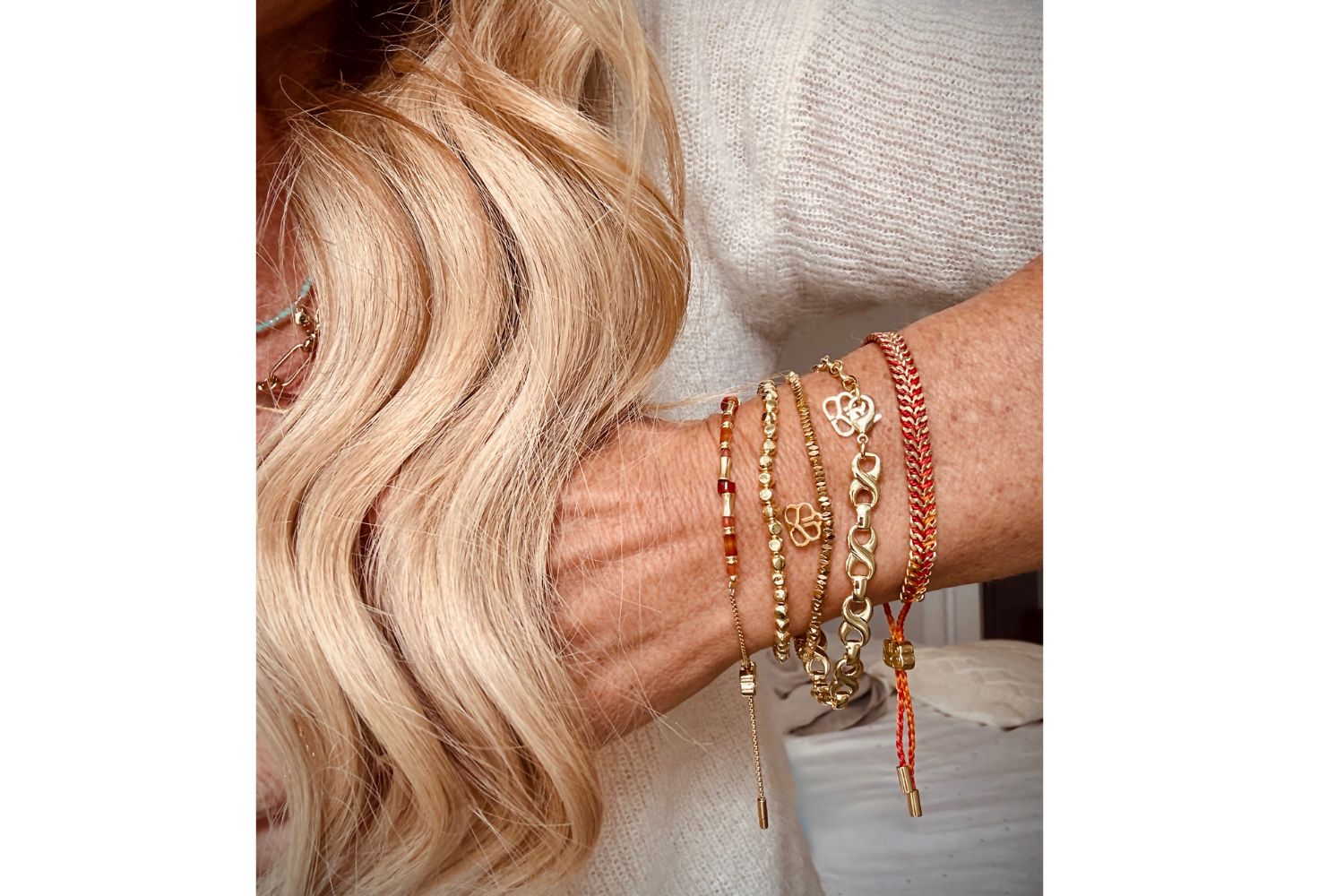 Glowing Sunset star of orange agate nestled in out a braided handwoven bracelet and stretchy gold nugget bracelet. Perfect sunset layering