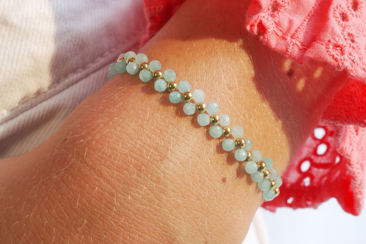 Marisol Gold & Amazonite Double Row Slider Bracelet worn in a colourful wrist stack with two rows of turquoise Amazonite gemstones, polished gold beads and crisp white cord.