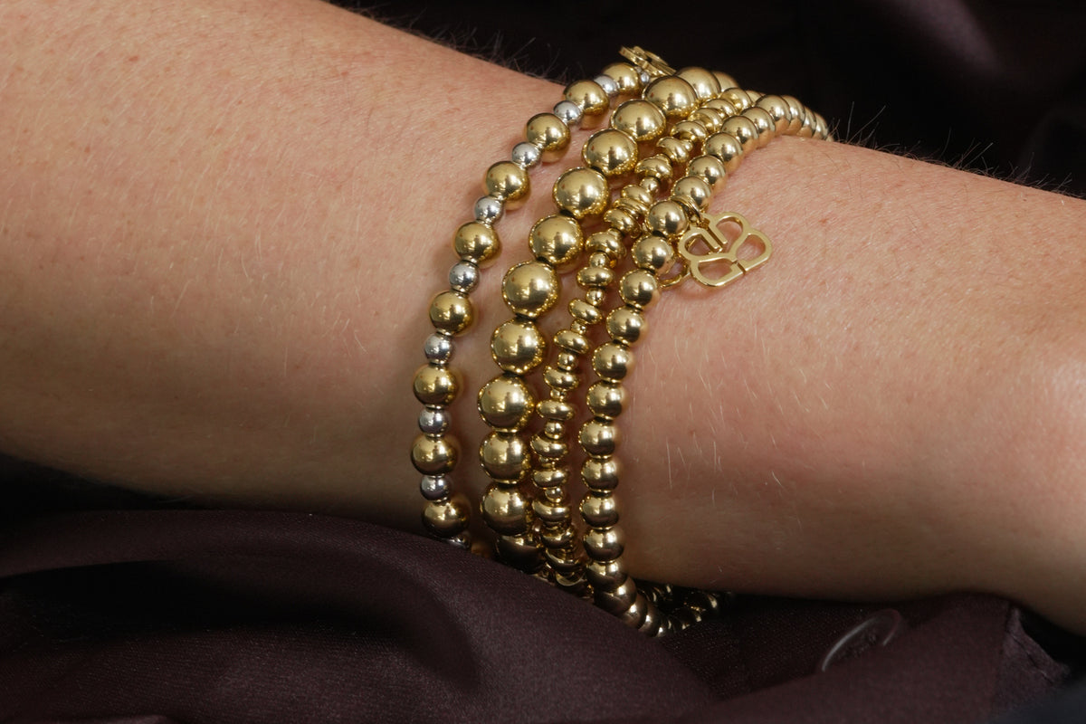 Cleo gold bead stretch bracelet by Boho Betty – styled in a stack, a stackable gold beaded stretch bracelet for everyday wear
