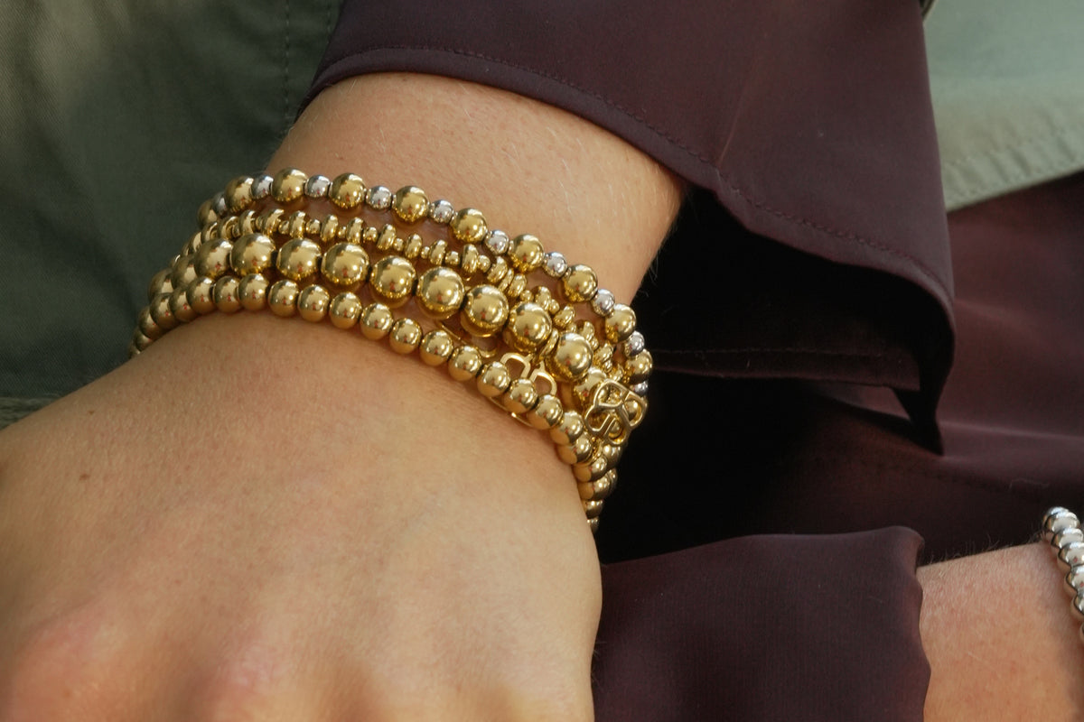 Enso gold stretch bead bracelet by Boho Betty – styled in a stack, a stackable gold beaded stretch bracelet for everyday wear