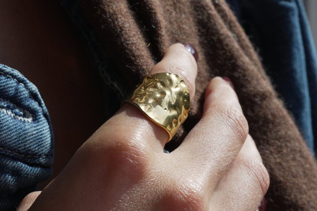 Nahla hammered gold adjustable ring by Boho Betty – worn on the hand, a chunky hammered gold adjustable statement ring