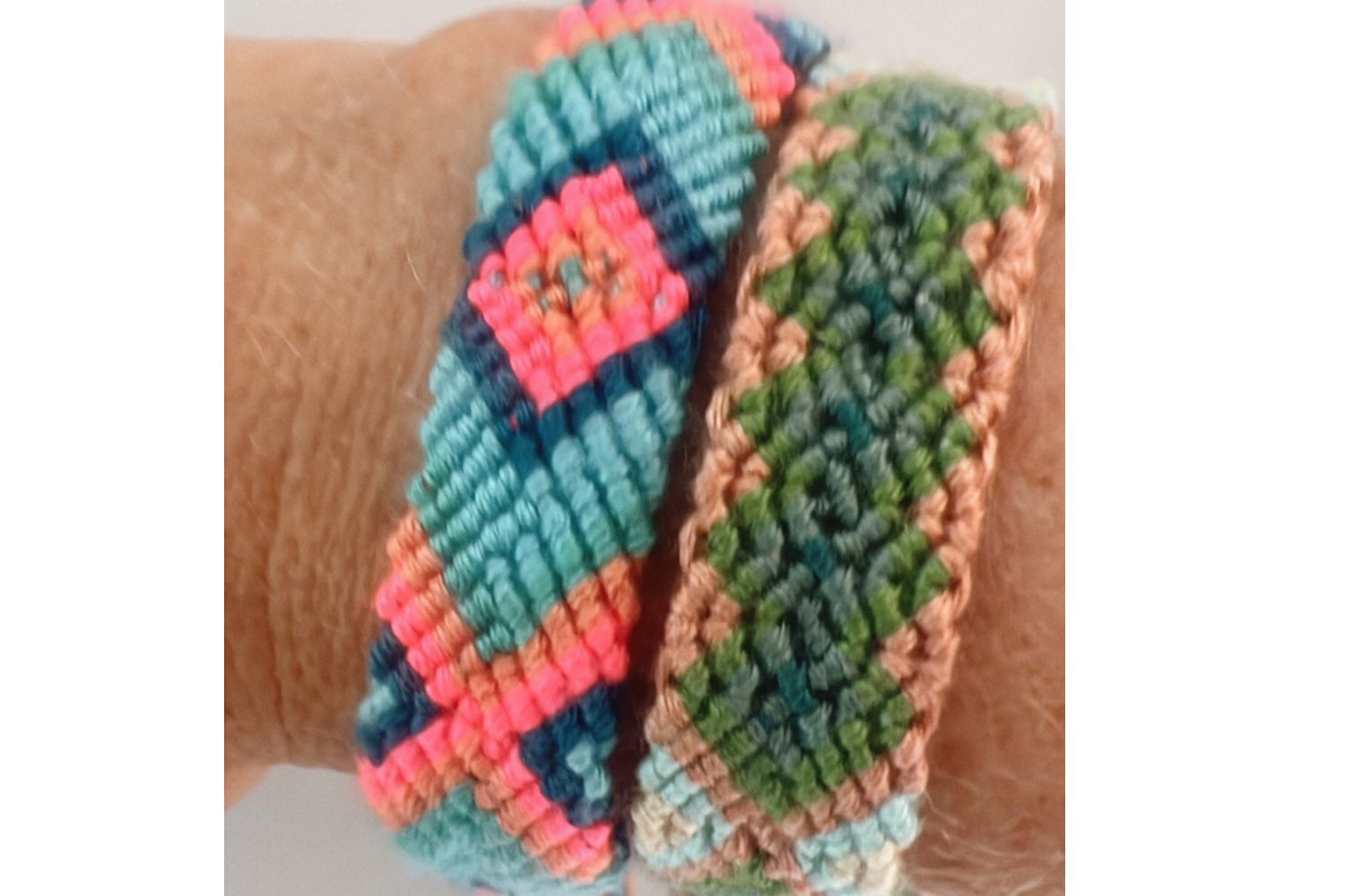 Colorful woven bracelet on a wrist against a neutral background
