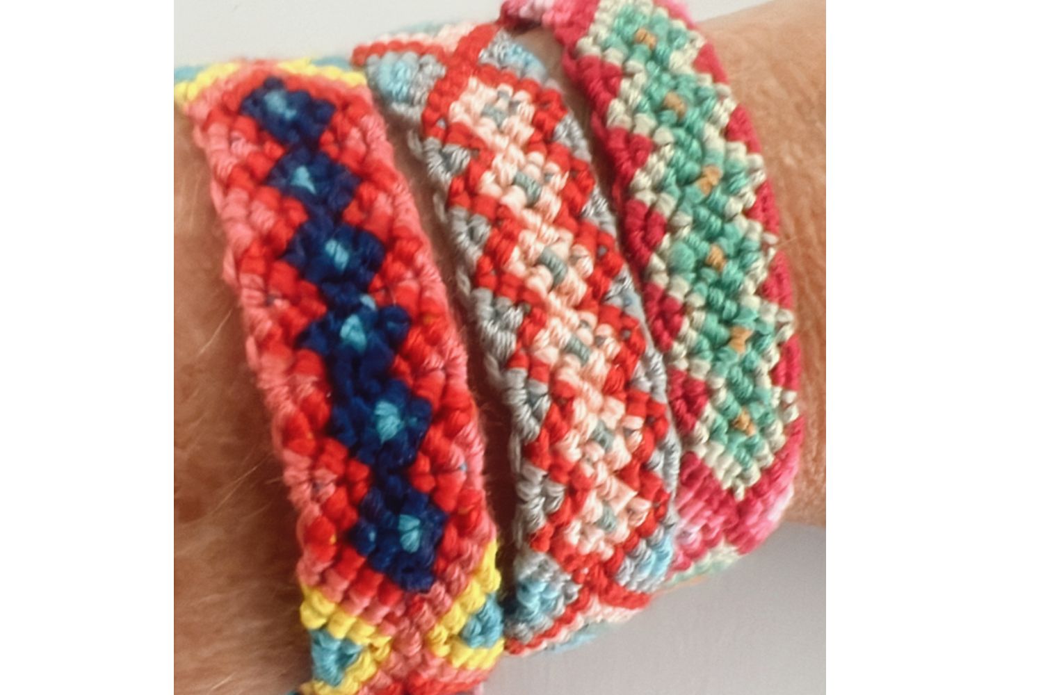 Colorful braided bracelets on a person's wrist
