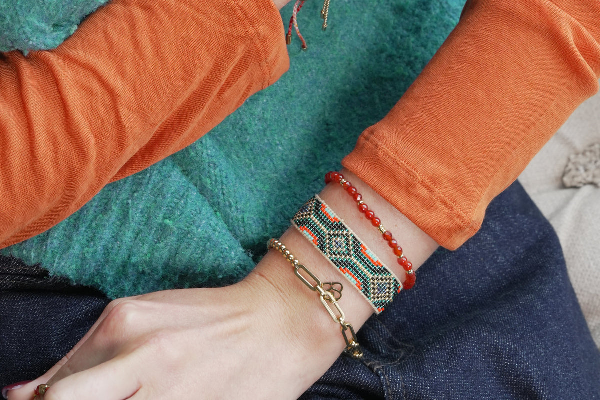 Camila teal and gold beaded cuff bracelet by Boho Betty – styled in a stack, a stackable gold and teal beaded cuff bracelet