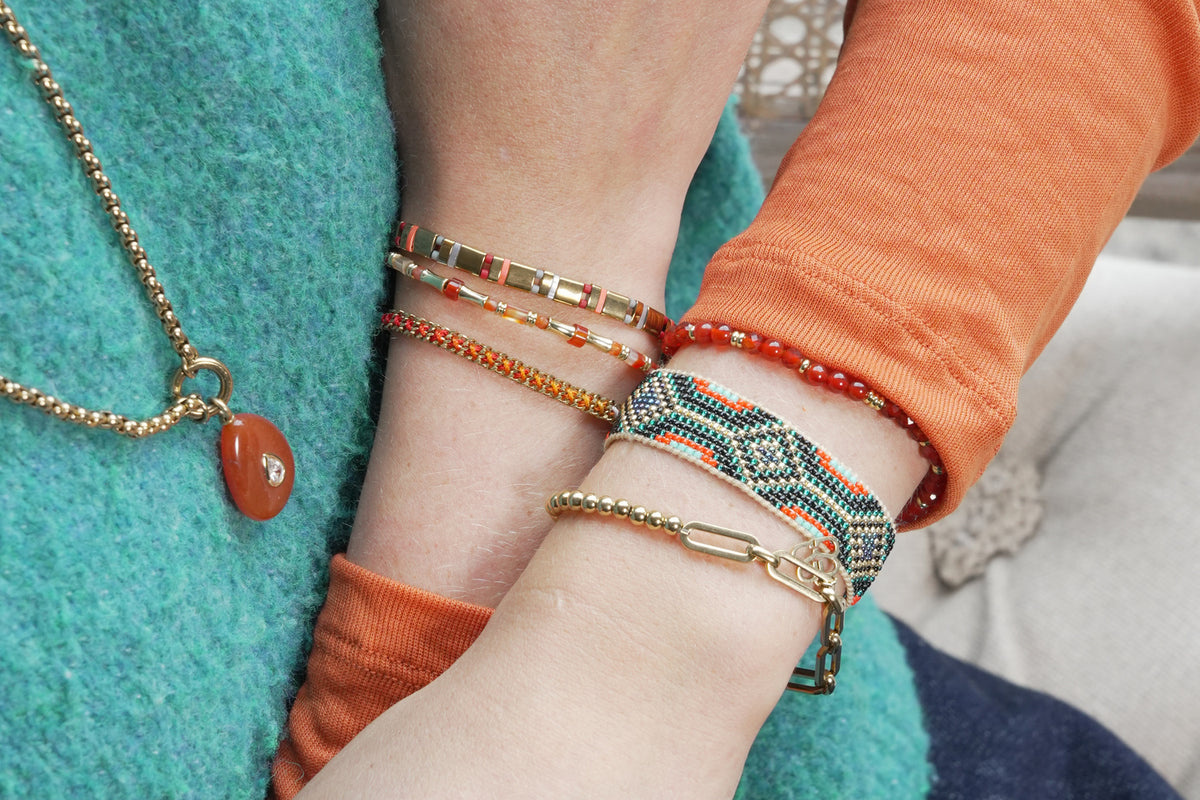 Camila teal and gold beaded cuff bracelet by Boho Betty – styled in a stack, a stackable gold and teal beaded cuff bracelet