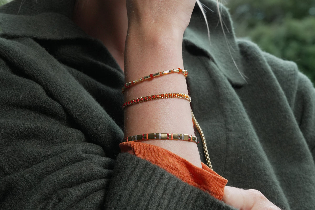 Lilia golden sunset ombre braided bracelet by Boho Betty – styled in a stack, a stackable gold braided bracelet