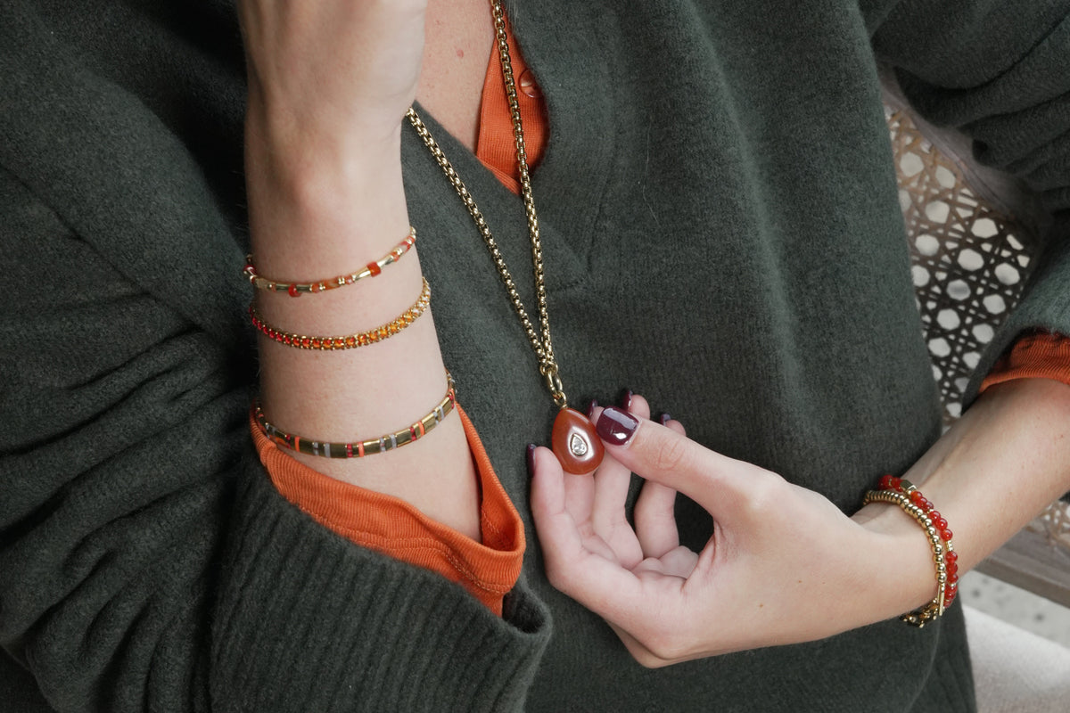 Thalia Fleur red aventurine gold teardrop pendant necklace by Boho Betty – styled with other jewellery, a gemstone necklace