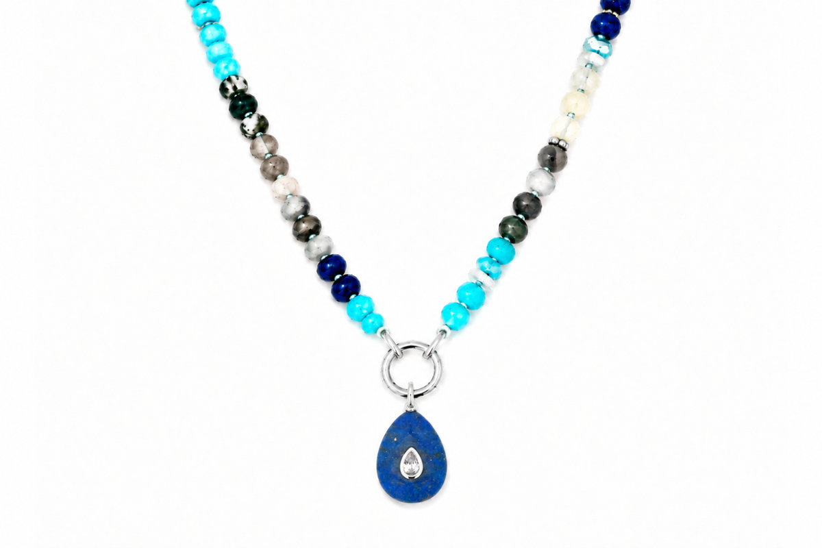 Amala Blue Mix silver charm carrier necklace finished with a Fleur lapis lazuli teardrop pendant, a waterproof Boho Betty gemstone necklace.