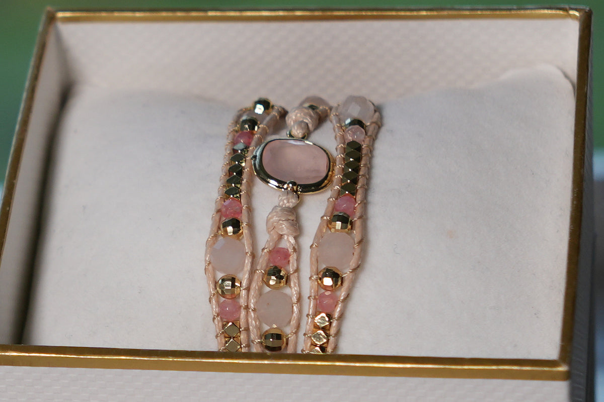 Close-up of the America Rose Quartz & Pink Tourmaline triple wrap bracelet, oval rose quartz centre stone, faceted pink beads and gold nuggets on blush cord