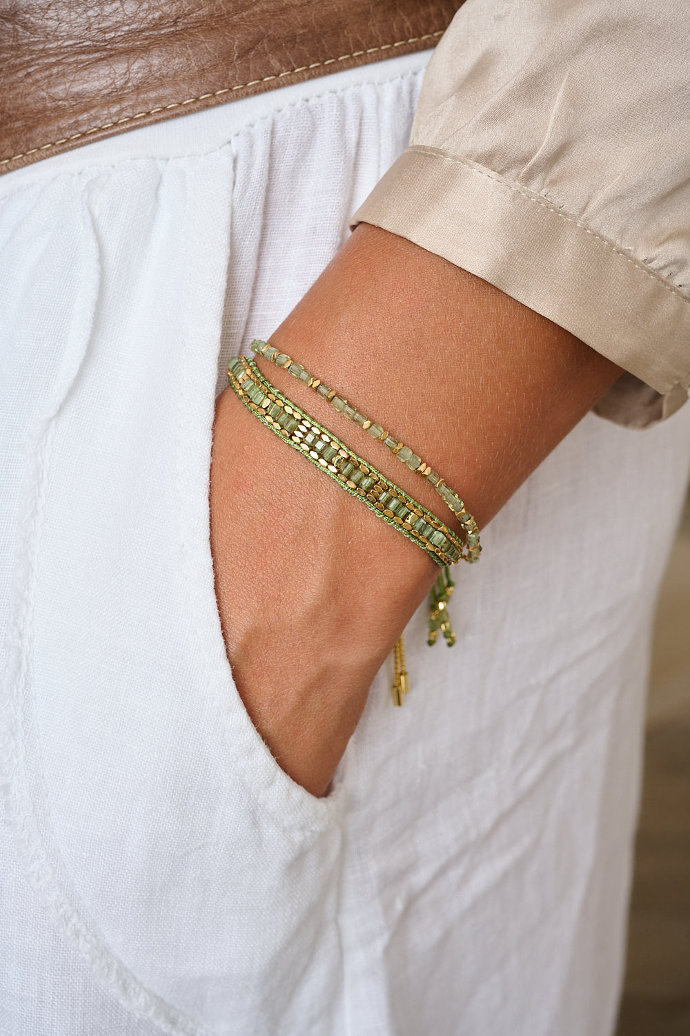 Anastasia Gold & Green Apatite Friendship Bracelet styled on the wrist, showcasing its vibrant green hues, gold accents, and effortlessly chic boho design.