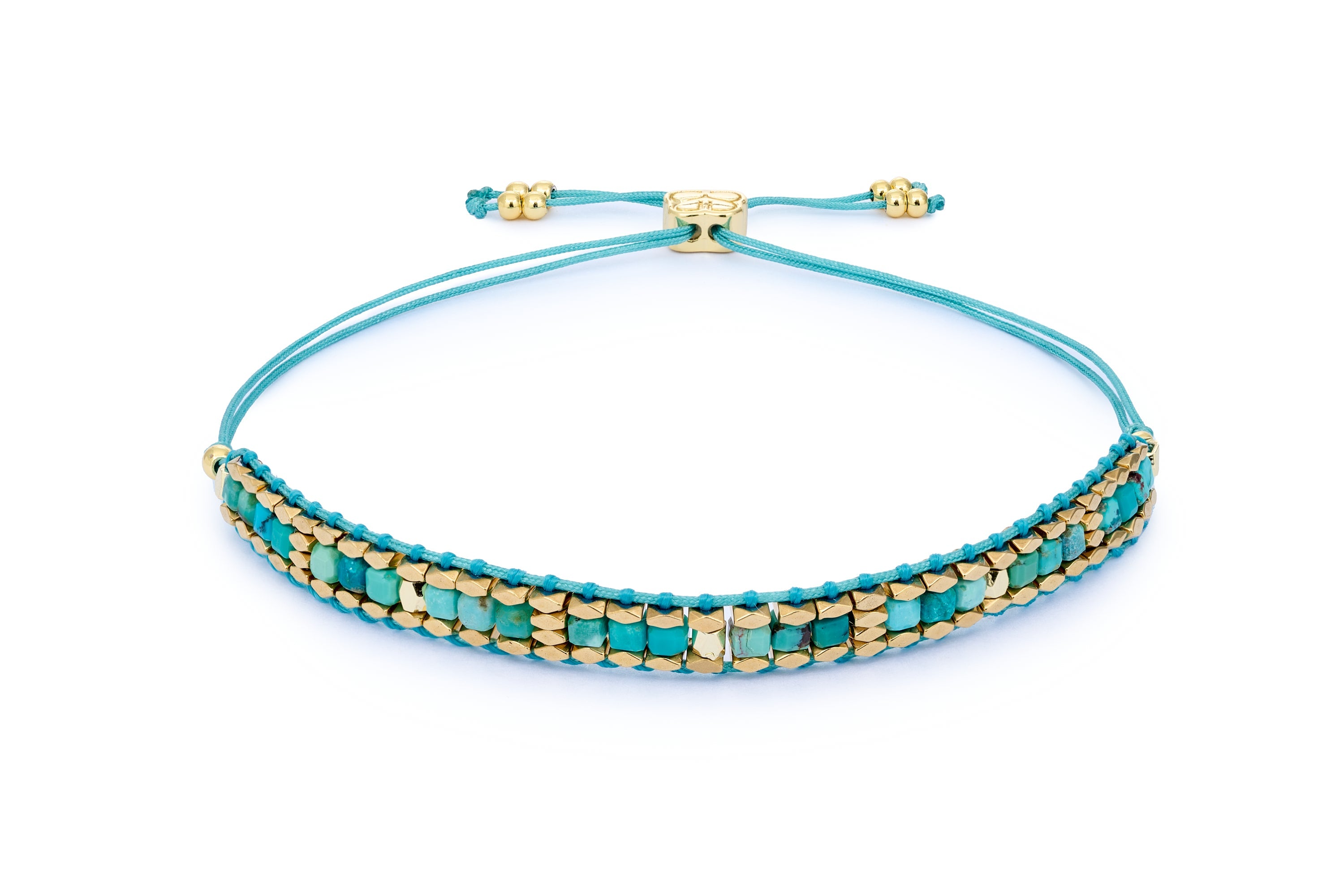 Anastasia Gold & Turquoise Howlite Bracelet featuring vibrant turquoise gemstones, gold-plated faceted beads, and an adjustable woven slider fastening for the perfect fit.