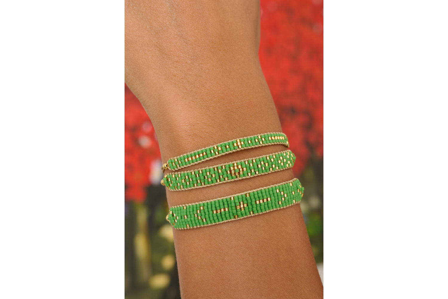 Aslan green and gold bracelet featured on wrist with Boho Betty stacking bracelets Maya and Grace.