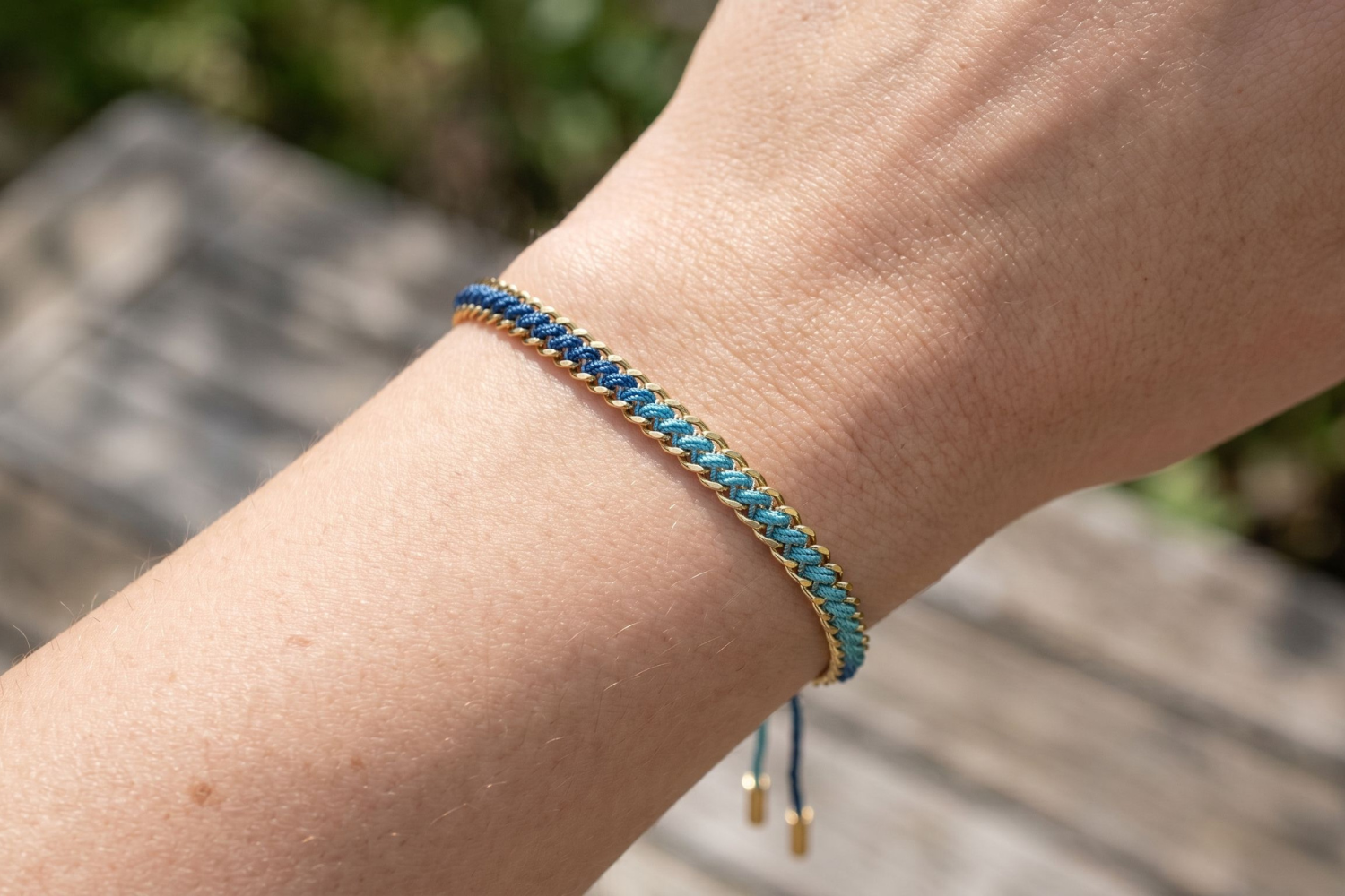 Athena sky blue woven bracelet styled on the wrist, a soft blue gold friendship bracelet perfect for stacking and everyday wear.