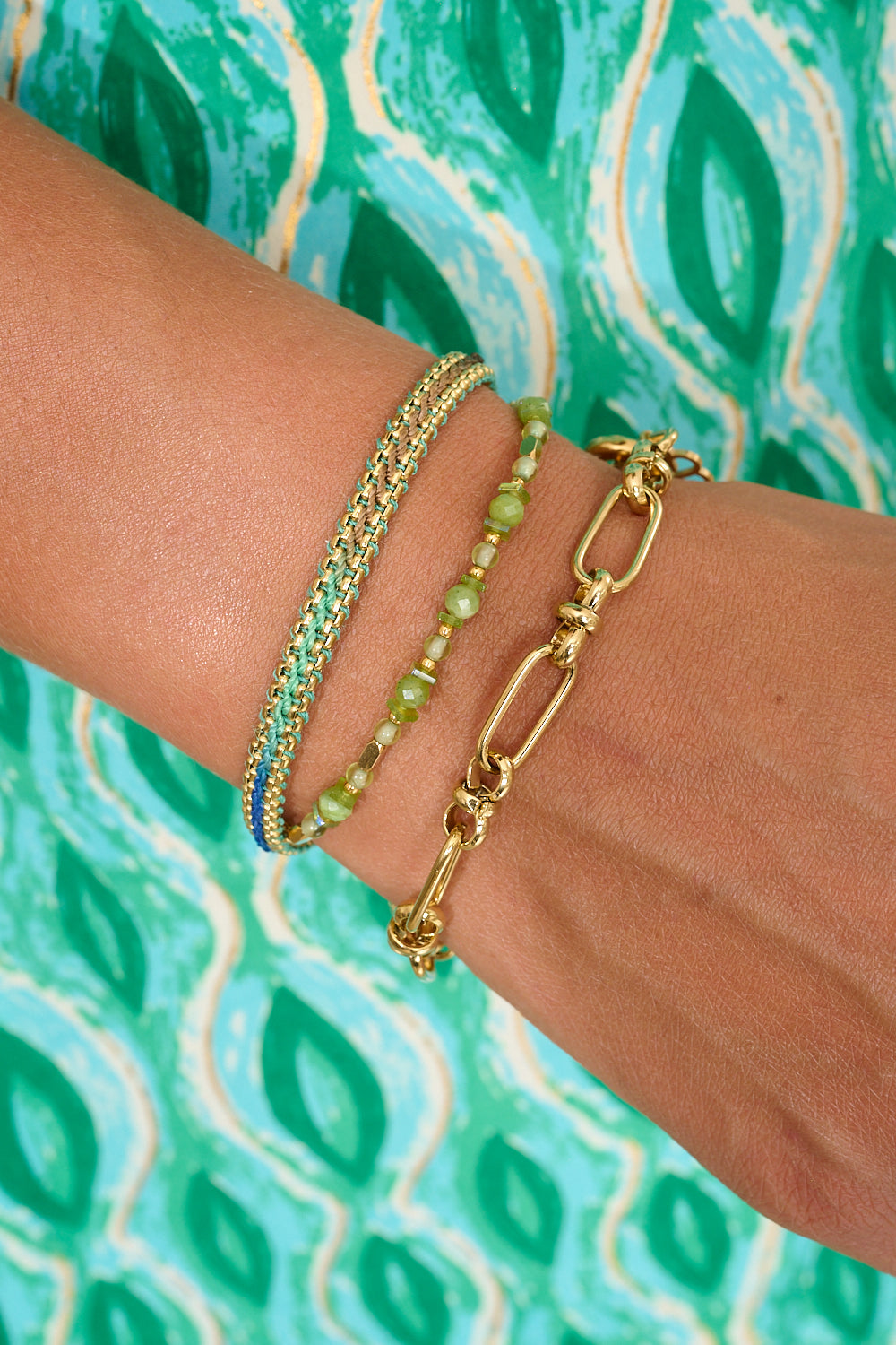 Aya gold green jade gemstone bracelet featured on the wrist with boho betty stacking bracelets