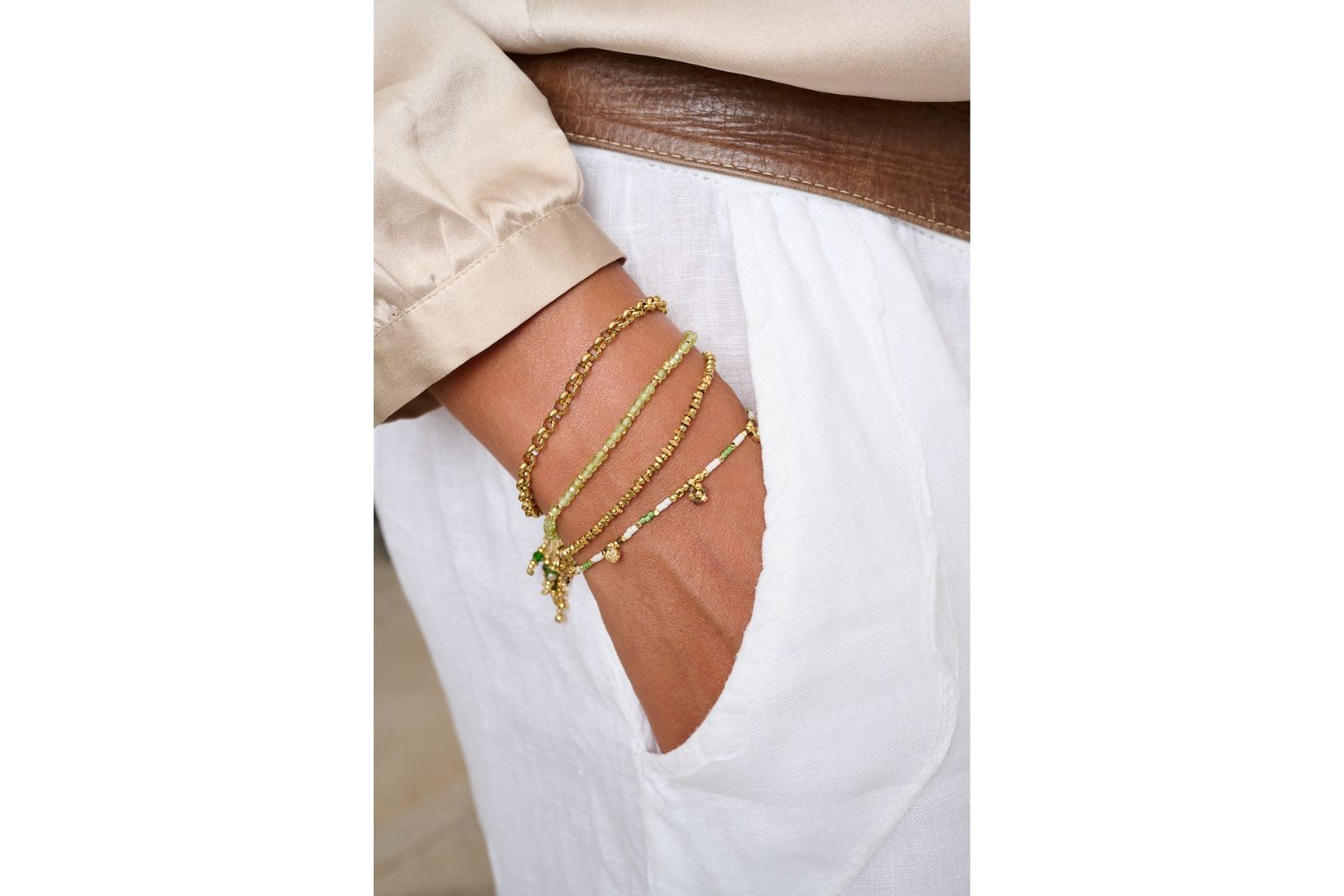 Ayla Gold Bead Stretch Bracelet styled on the wrist, showcasing golden beads and BB charm for an effortlessly luxe, boho-inspired look.