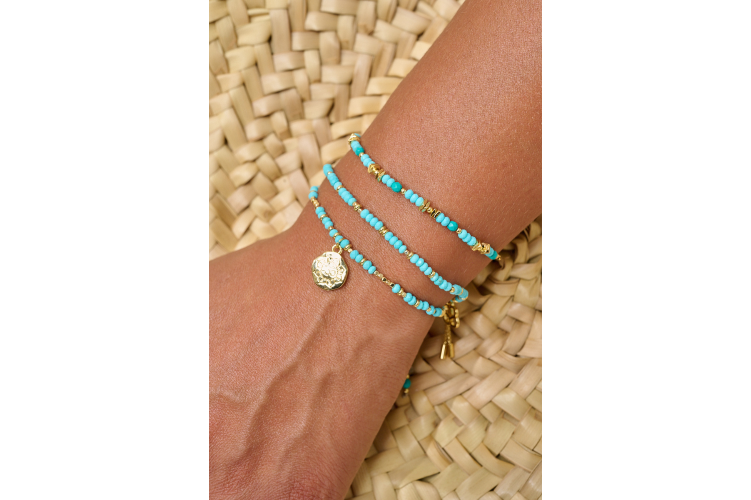 Azalea gold turquoise howlite Om charm bracelet featured on wrist with Boho Betty stacking bracelets