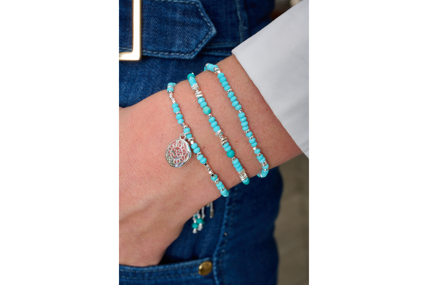 Azalea silver turquoise howlite Om charm bracelet featured on wrist with other Boho Betty stacking bracelets