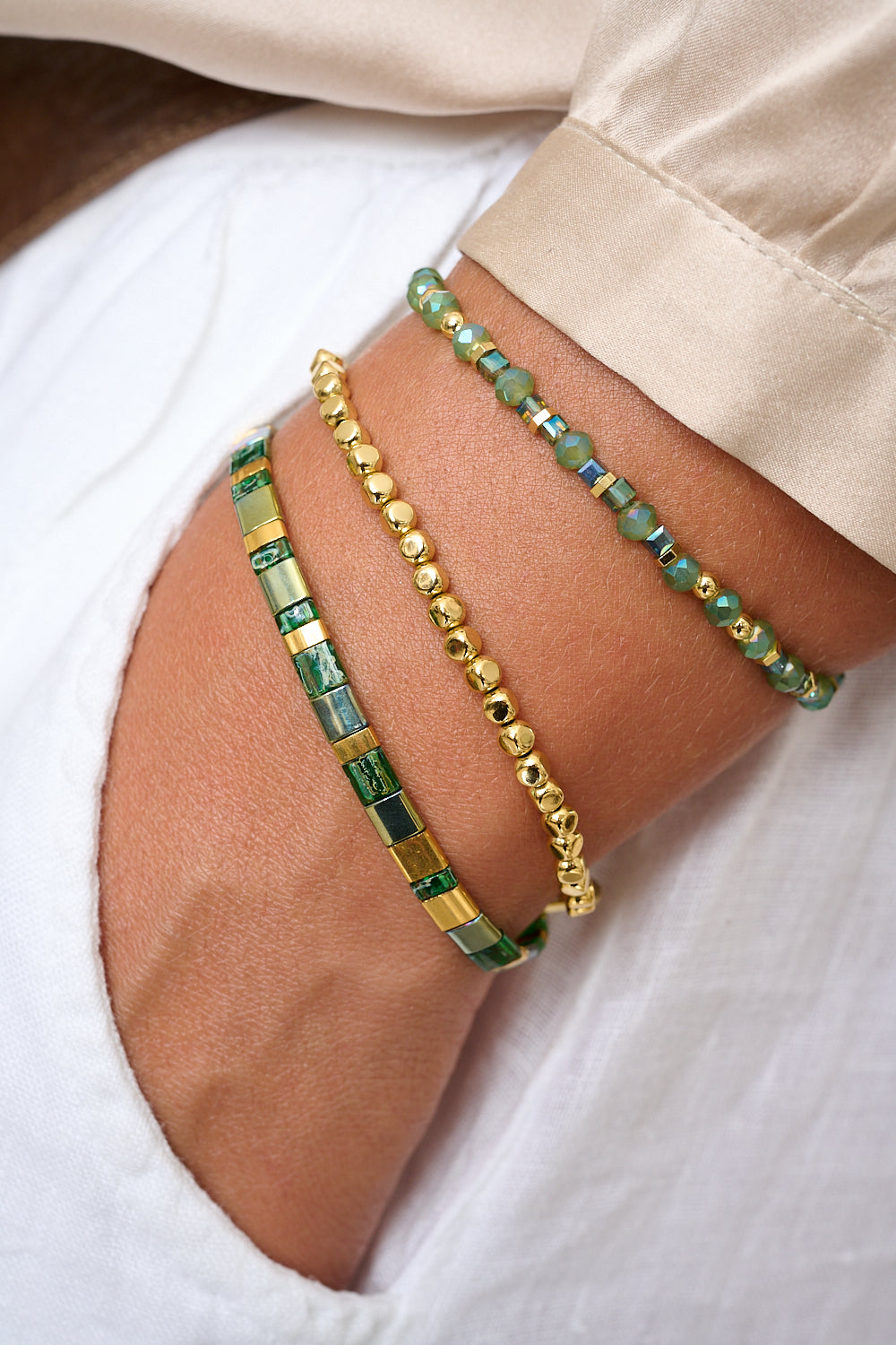 Basil green tila bead bracelet featured on wrist with Boho Betty gold stacking bangles