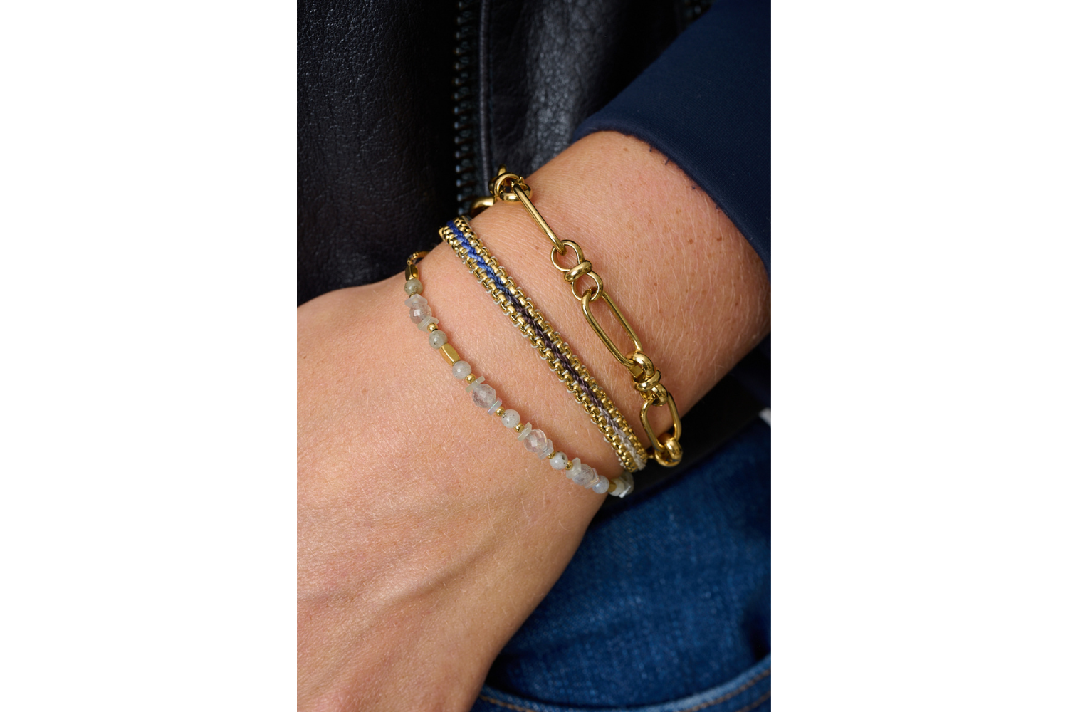 Bloom Denim Gold Braided Bracelet styled on the wrist, featuring a blue ombre thread and gold chain accents, ideal for summer adventures or everyday wear.