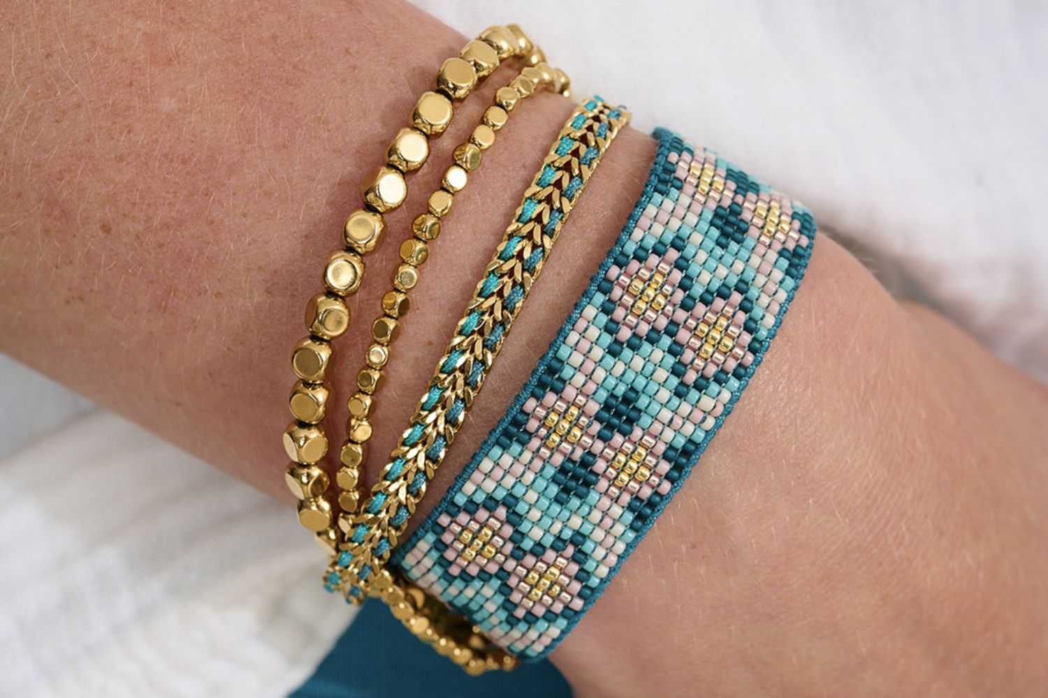 Charlotte Teal Gold Beaded Friendship Bracelet styled on the wrist, showcasing teal and gold Miyuki beads, perfect for layering with other boho jewellery or wearing solo.