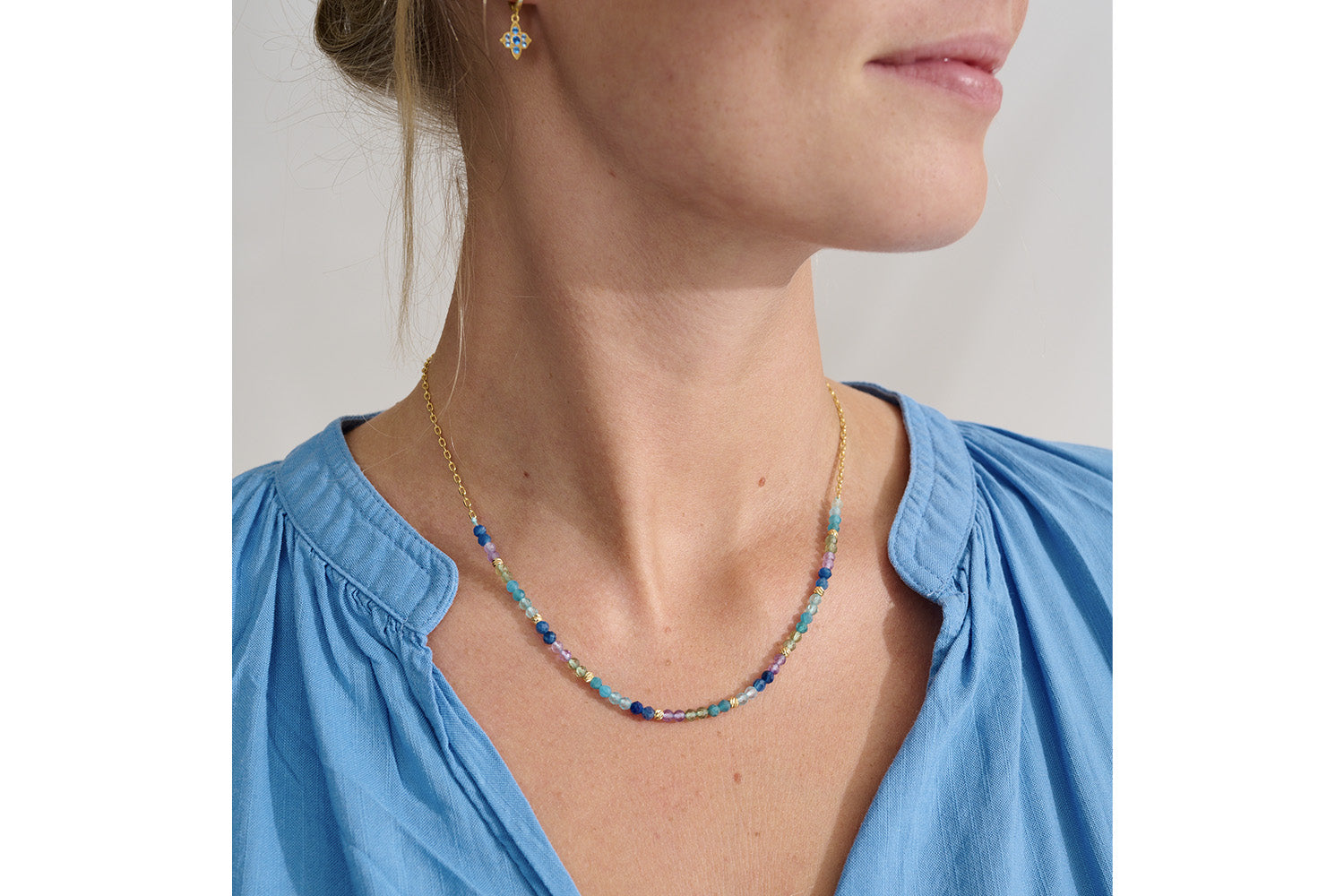 Clover Gold & Apatite Mix Gemstone Bead Necklace styled for boho-chic looks, showcasing shimmering gemstones in vibrant blues and greens with golden accents, perfect for layering or wearing solo.
