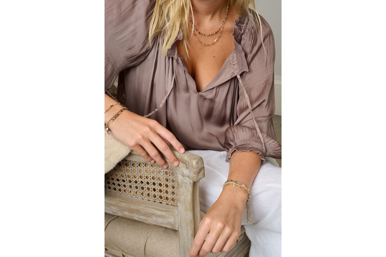 Estelle Taupe & Gold Bracelet styled on wrist with neutral fashion and layered boho gold bracelets, adding soft sparkle and celestial detail.