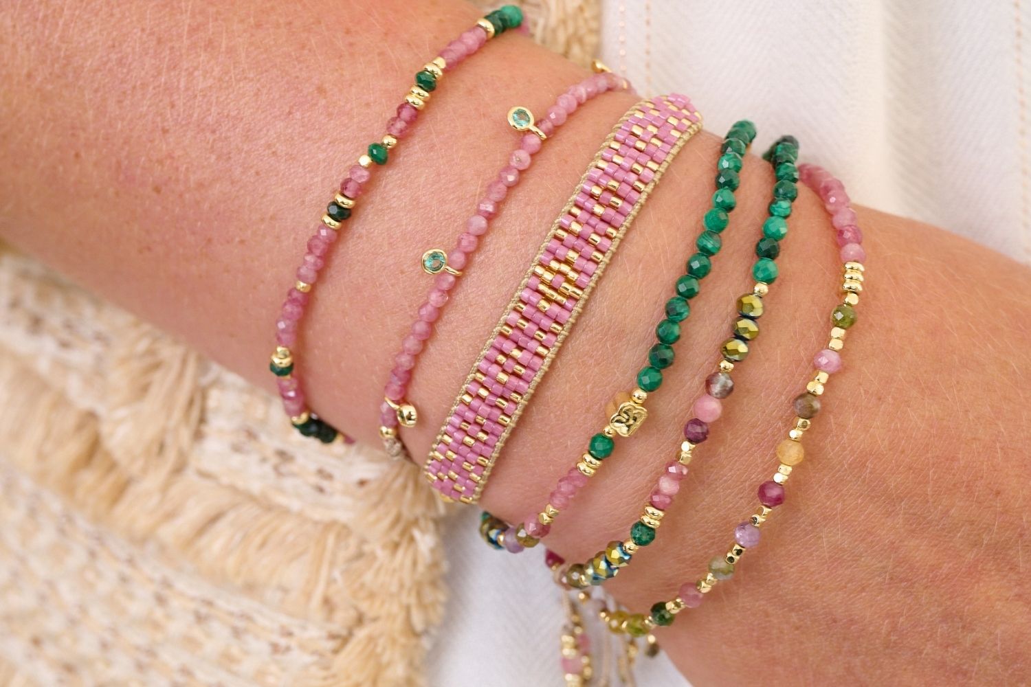 Holly Gold & Pink Tourmaline Beaded Charm Bracelet styled on the wrist, showcasing pink tourmaline beads and gold accents with delicate CZ charms, adding a touch of sparkle to any look.
