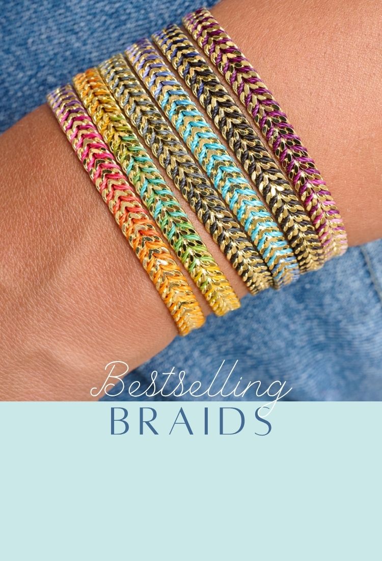A vibrant stack of Boho Betty’s Iztac braided bracelets in rainbow hues—featuring metallic gold and silver chevron-style weave with pops of colour from pink, orange, yellow, green, turquoise, and purple threads.  The text reads: “Bestselling Braids.”