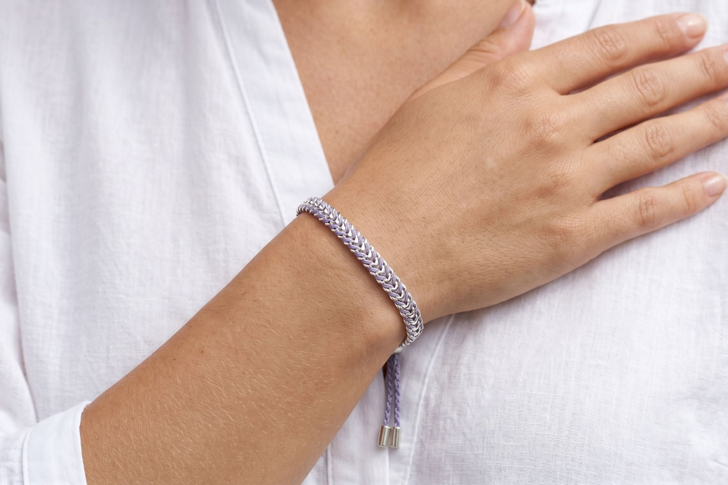 Iztac Lilac Silver Woven Bracelet styled on the wrist, showcasing soft lilac woven detailing and polished silver accents for relaxed boho styling.