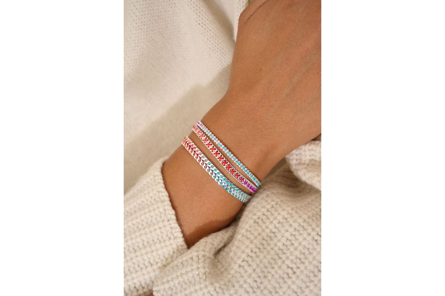 Iztac Moroccan Spice Silver Braided Bracelet styled on the wrist, showcasing vibrant threads and polished silver links for a bold, travel-inspired look.