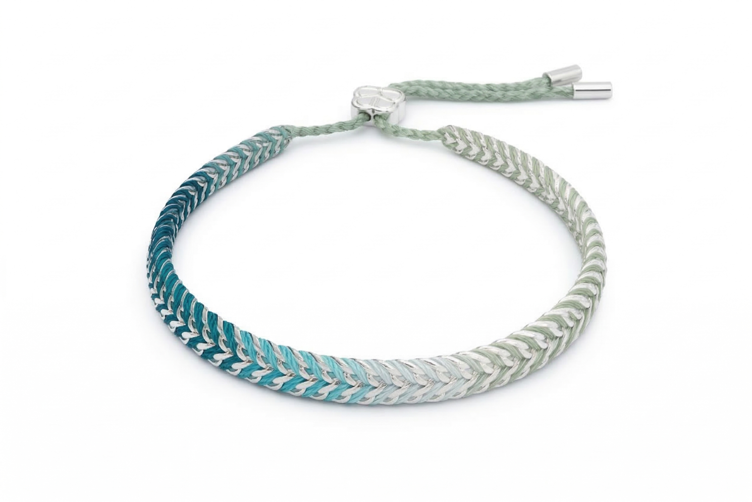 Iztac SKY Silver & Blue Ombre Braided Bracelet worn with a soft knit, showcasing the cool blue ombré weave and sleek silver chain detailing.