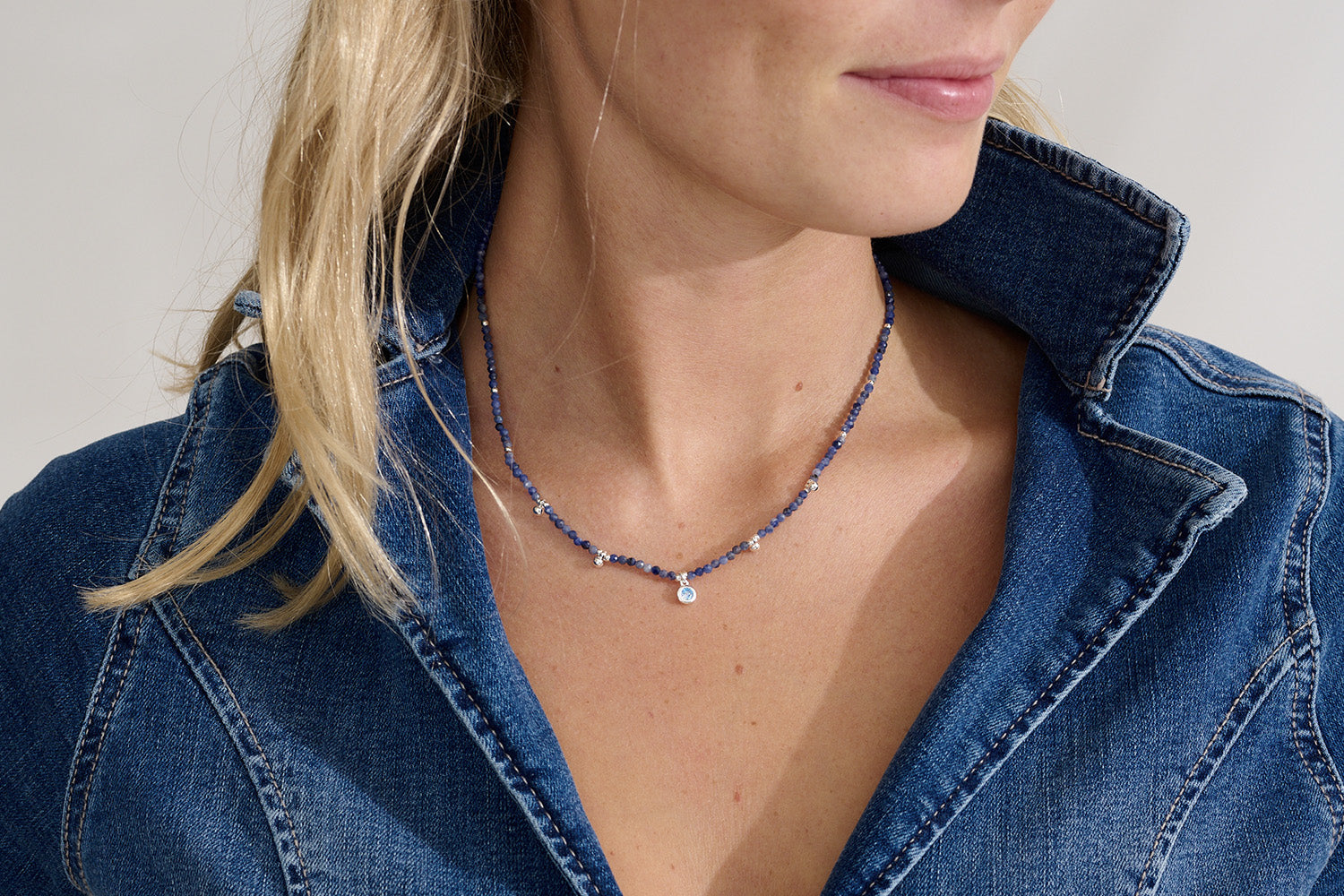Jasmine Silver & Blue Aventurine Pendant Necklace styled on the neck, featuring blue Aventurine beads, a CZ pendant, and silver accents, perfect for layering or wearing solo.