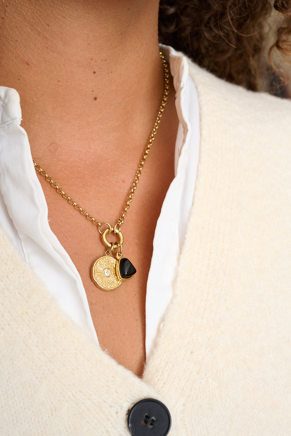 Kallisto black agate pendant styled with gold charm necklace