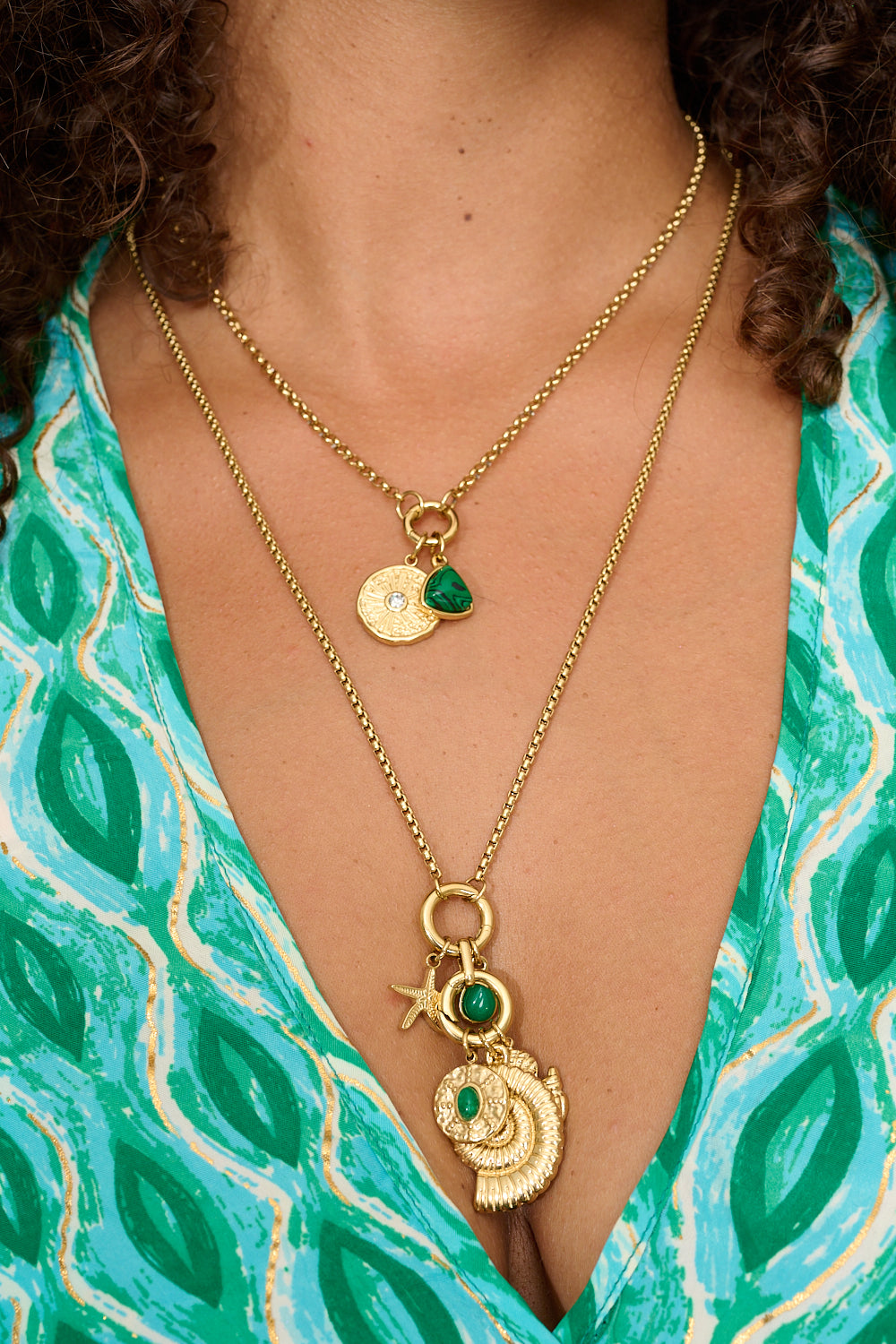 Kallisto malachite pendant styled on gold charm necklace stack