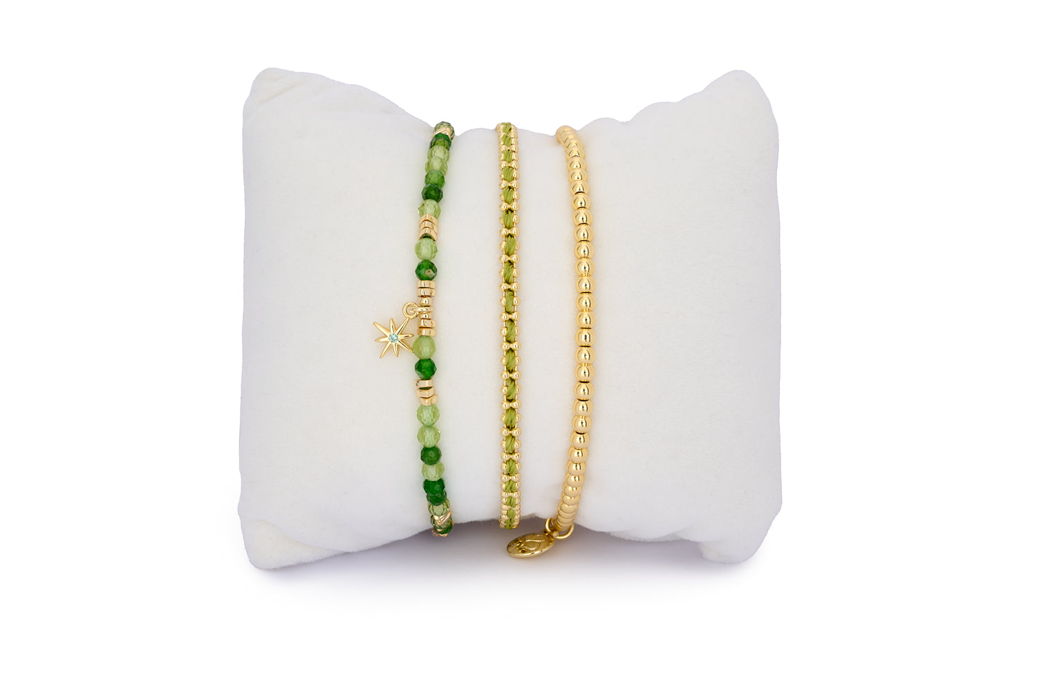 Kauai Peridot & Gold Bracelet Stack featuring three vibrant gold-tone bracelets with green gemstones, braided cord and beaded detailing for a joyful boho-chic look.